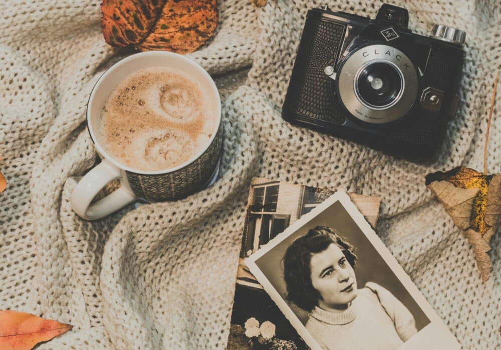 Coffee, camera, and vintage photographs.