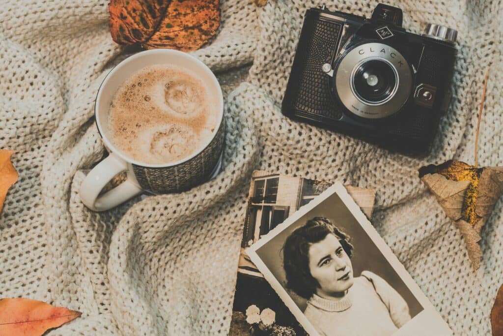 Coffee, camera, and vintage photographs.